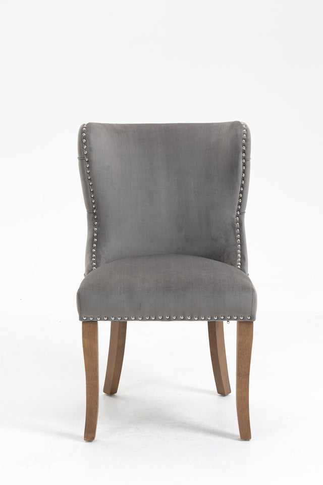 Set of 2 upholstered wing-back dining chair with backstitching nailhead trim and solid wood legs